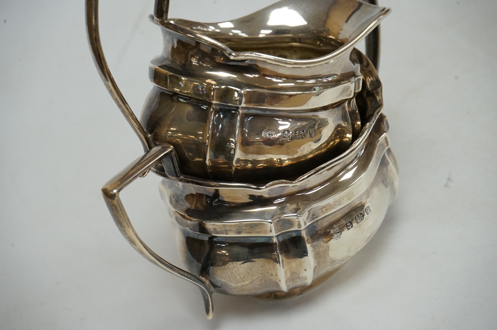 A George V silver oval three piece tea set, by Alexander Clark & Co Ltd, Birmingham, 1914 & 1916, gross weight 18.9oz.
